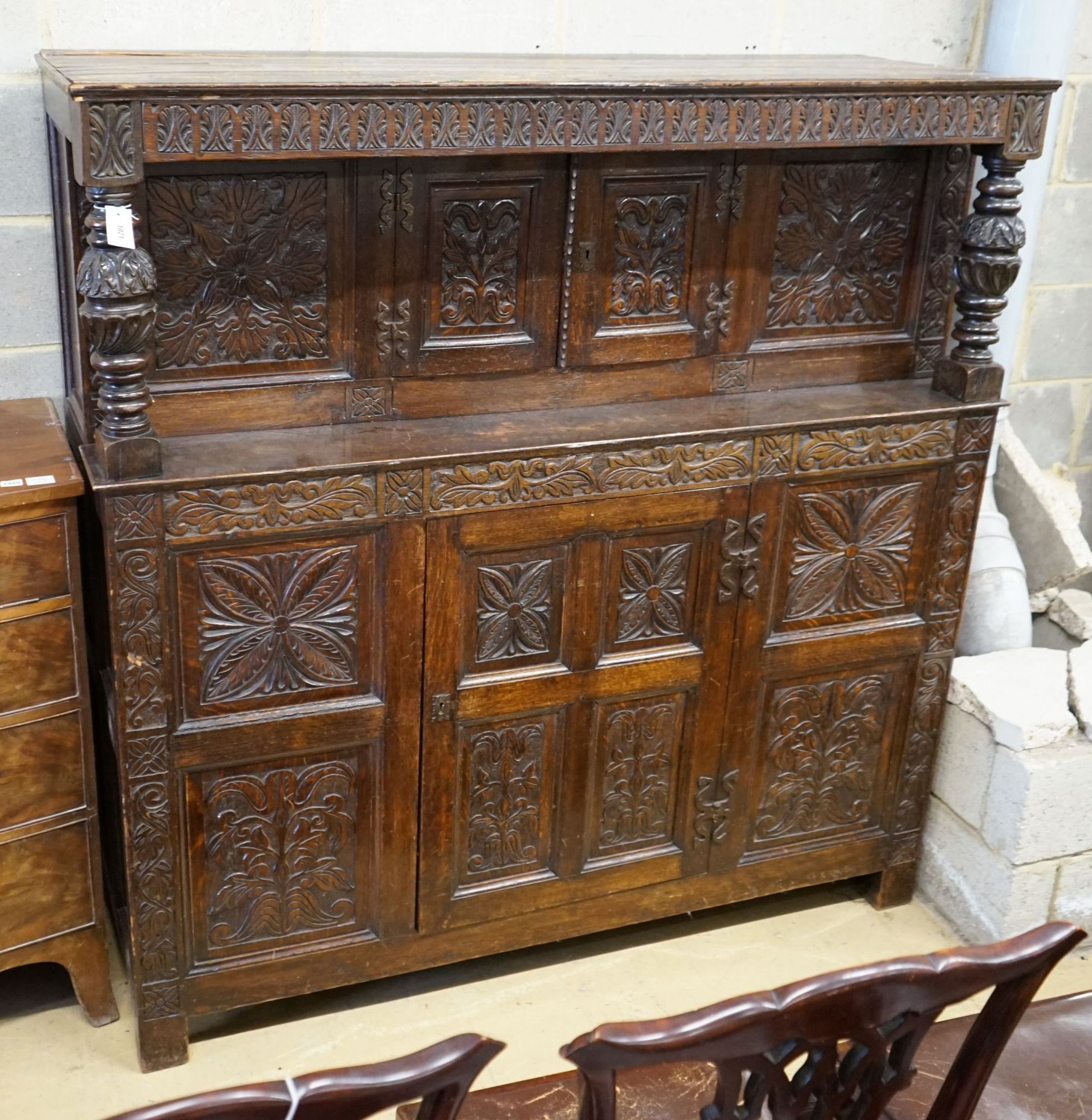 An 18th century style carved oak court cupboard, width 161cm, depth 54cm, height 164cm